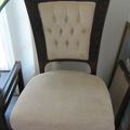 low upholstered chair with carved wood